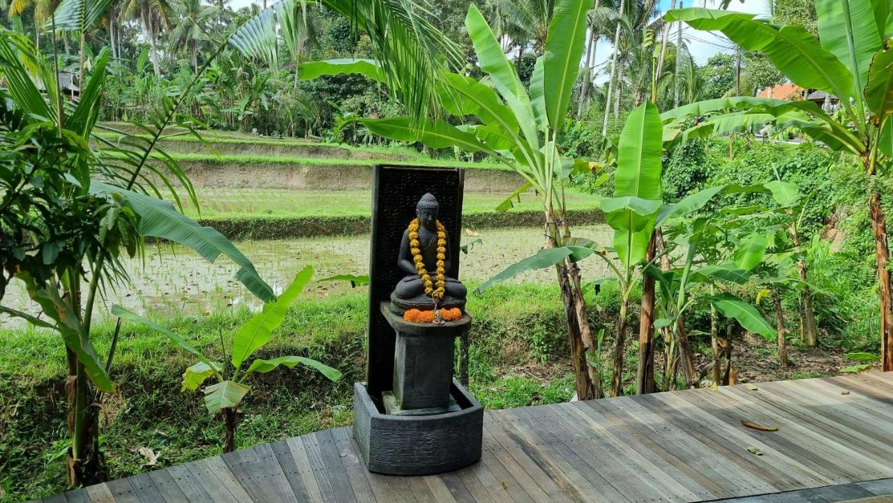 The Sebali Resort Ubud Extérieur photo A statue of the Buddha with a mala